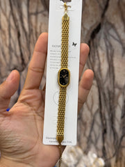 The image displays a matching set of gold-colored stainless steel jewelry