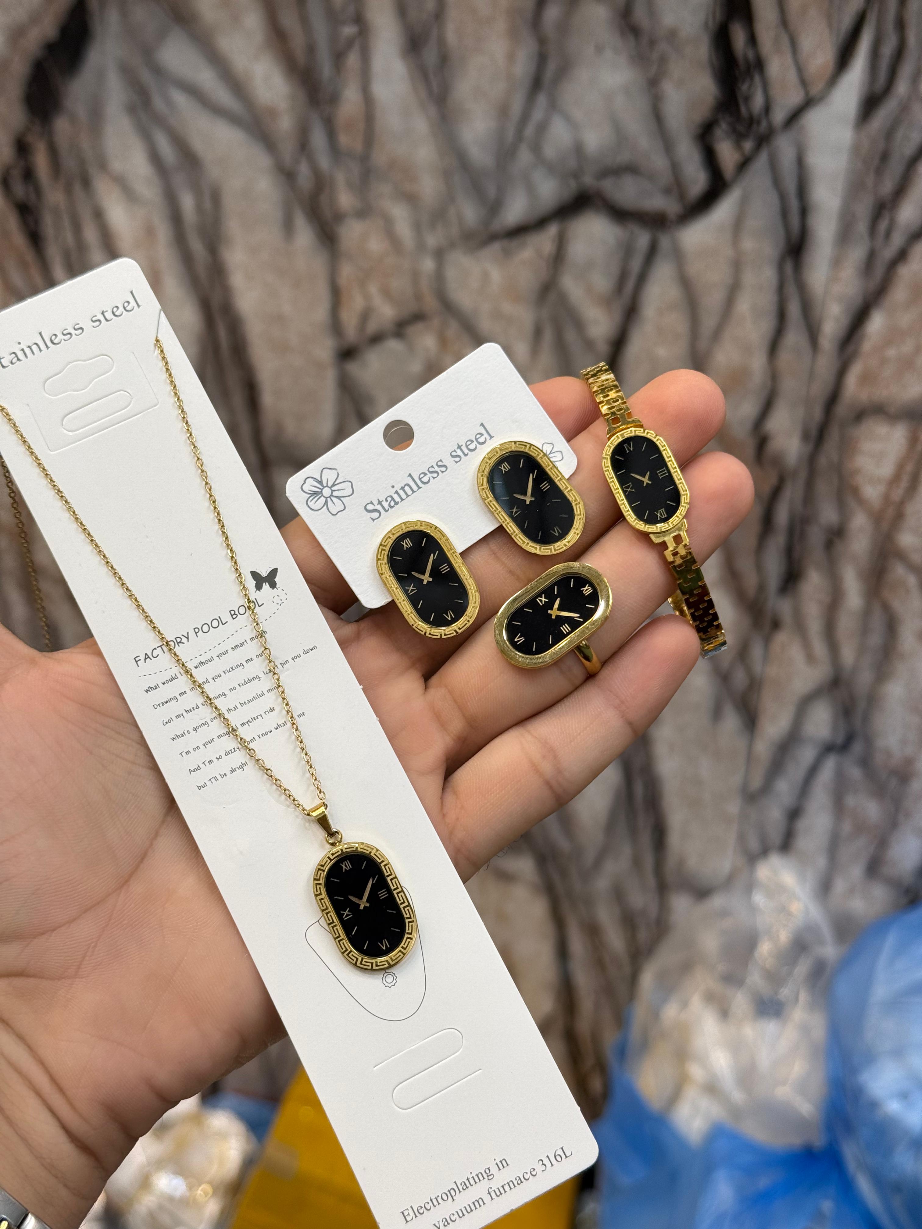 The image displays a matching set of gold-colored stainless steel jewelry