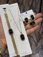The image displays a matching set of gold-colored stainless steel jewelry